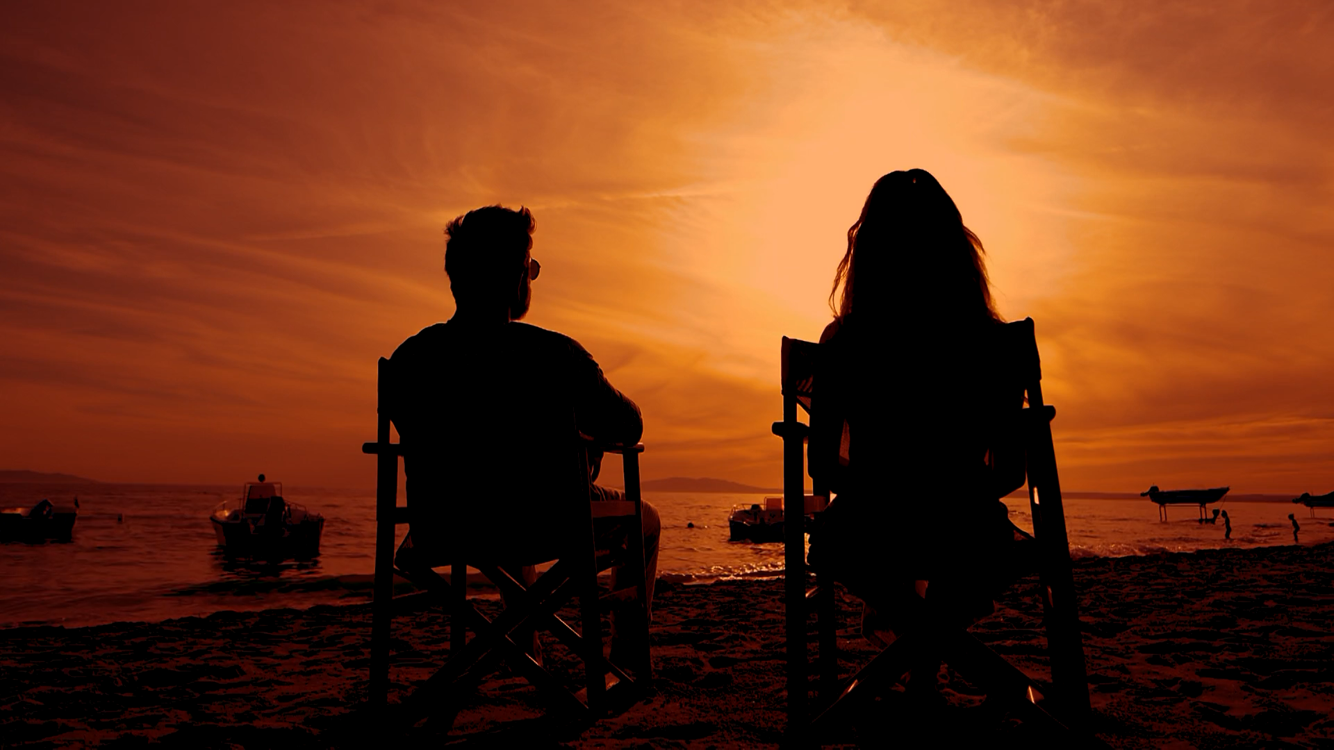 Woman Walking Away from Man Sitting on Beach Chairs